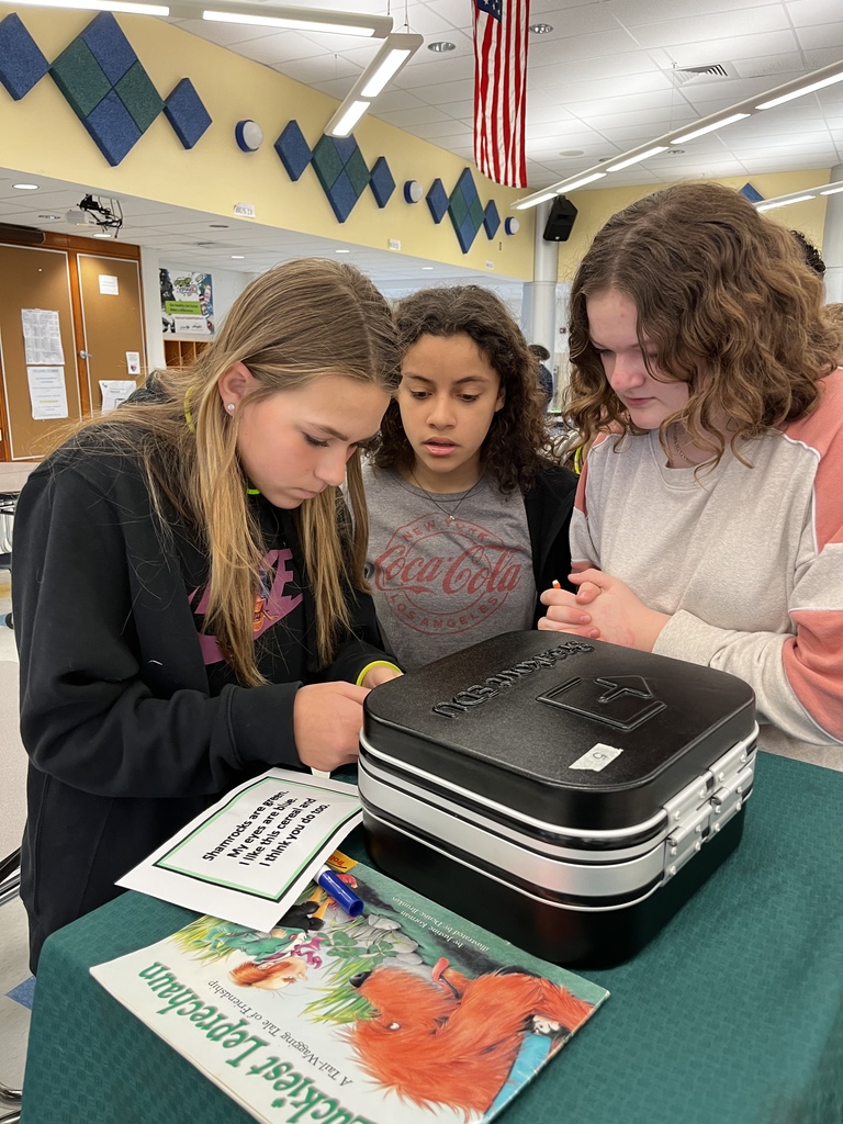 6th grade students attempting breakout box